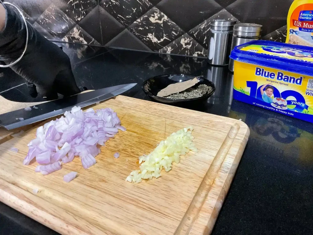 Cutting And Chopping Onion And Garlic In Mustard Chicken